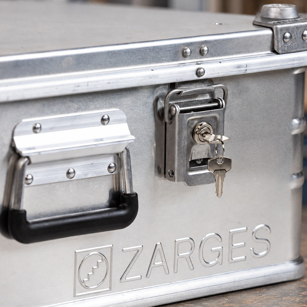 ZARGES 40832 lock fitted to an aluminium case with the key inserted